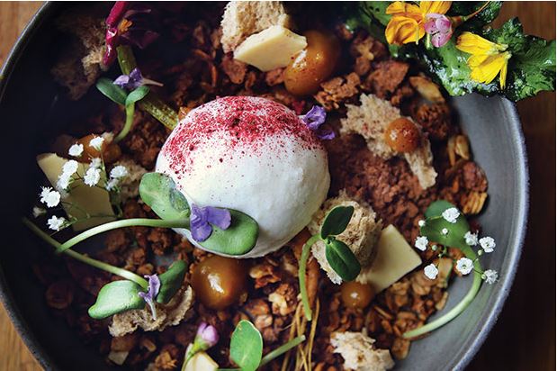 Coconut sorbet—made with the juices of mandarin and yellow beet, and sprinkled with house beet sugar—sits atop hazelnut and coffee cocoa granola, roasted white chocolate bark, hazelnut and fresh yeast sponge and candied baby beet greens from Eden Hill in Queen Anne