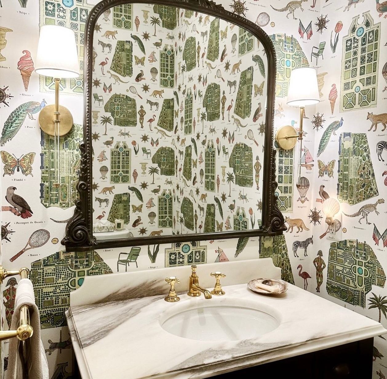 Just put the finishing touches on this powder room refresh in Arlington, featuring Pierre Frey&rsquo;s #iconic Jardins Parisiens wallpaper as well as some gorgeous @waterworks fixtures and sconces from @visualcomfort (while keeping the original mirro