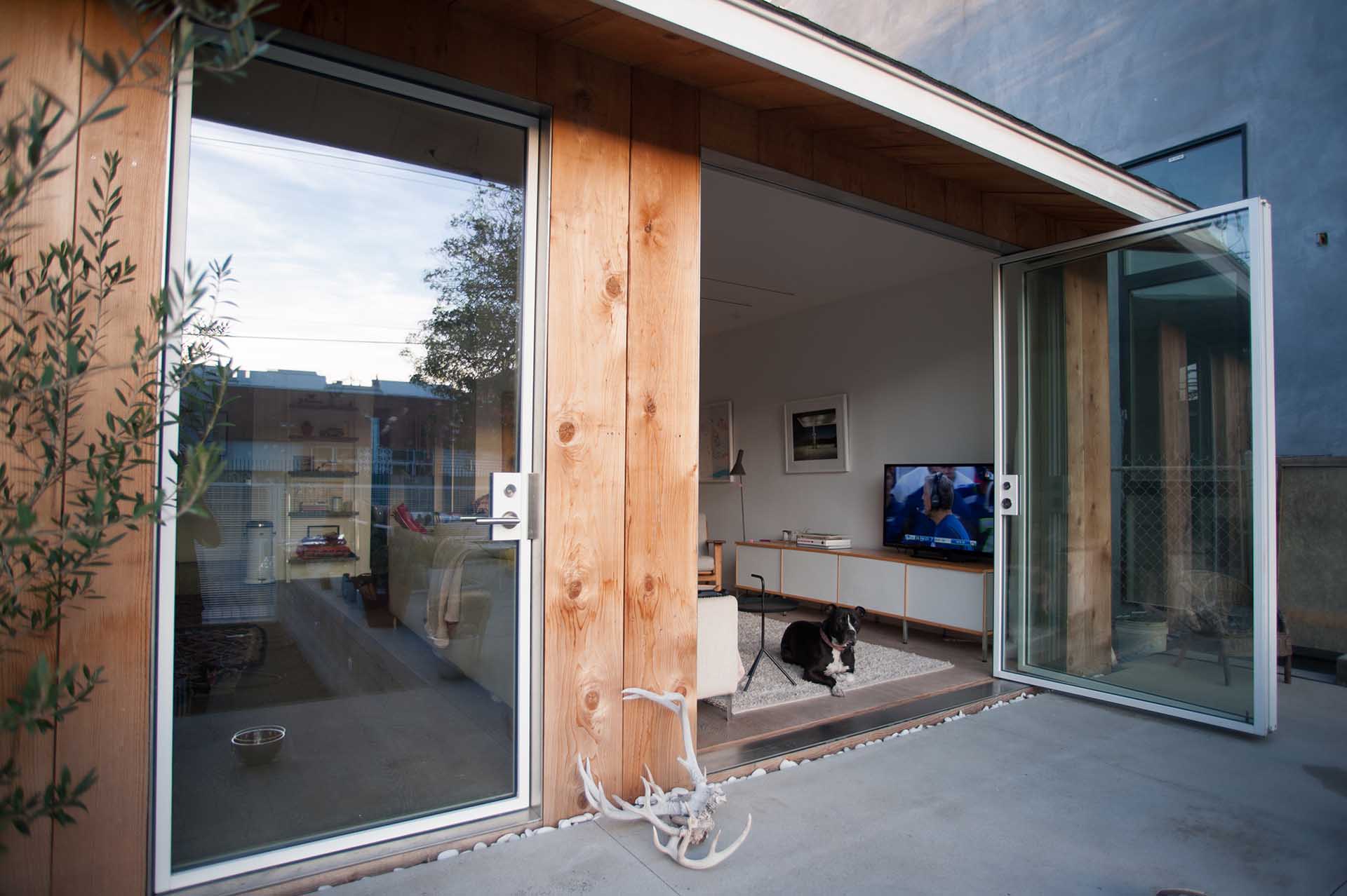 Solid aluminum bar frames, milled to accept glass. Custom-made pivot hinges and sliding mechanism. Stainless steel flat bar jambs, headers and thresholds. FSB hardware. Low e insulated glass.