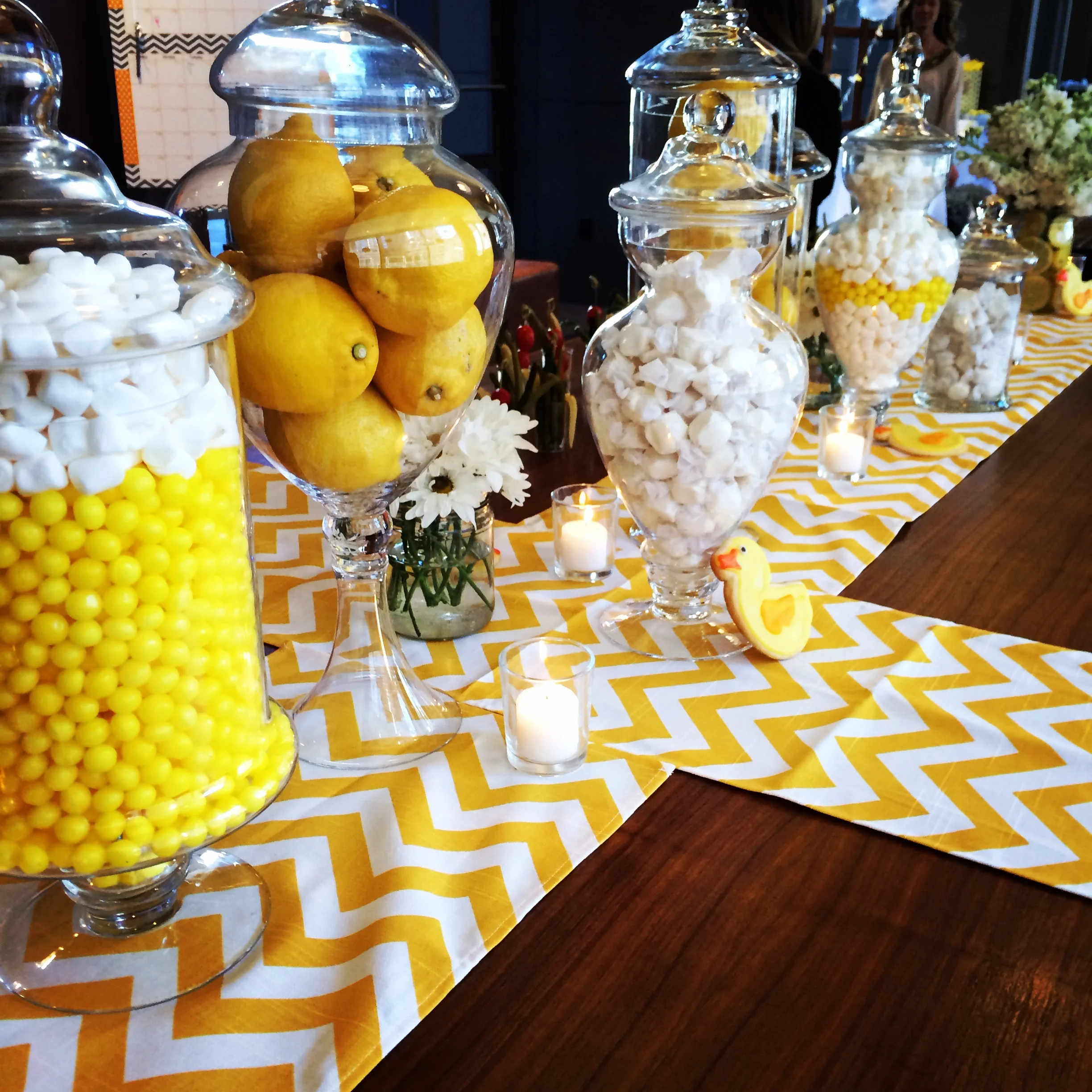Decorative jars filled with candy and lemons and bright chevron runners