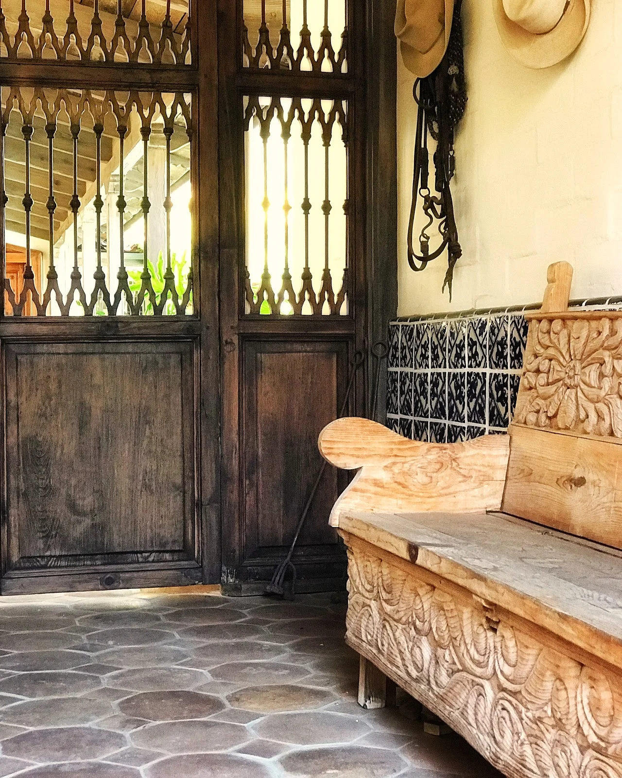 Pierced walnut entry doors that lead to the hacienda’s inner courtyard