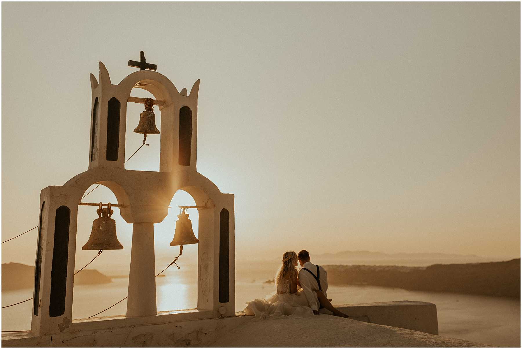 A sunset wedding is Santorini Greece