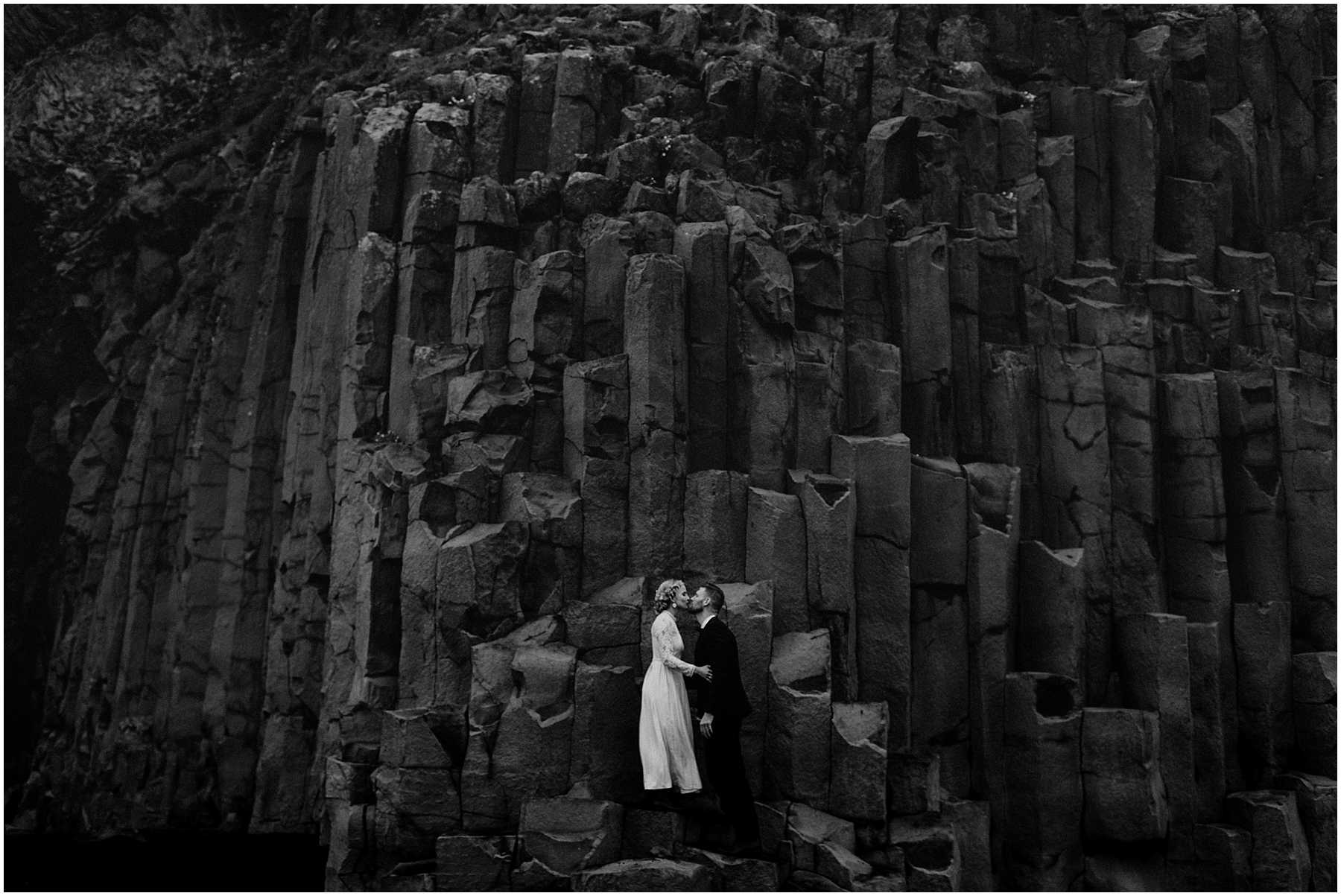 A bride and groom at Black Sands Beach in Vik, Iceland