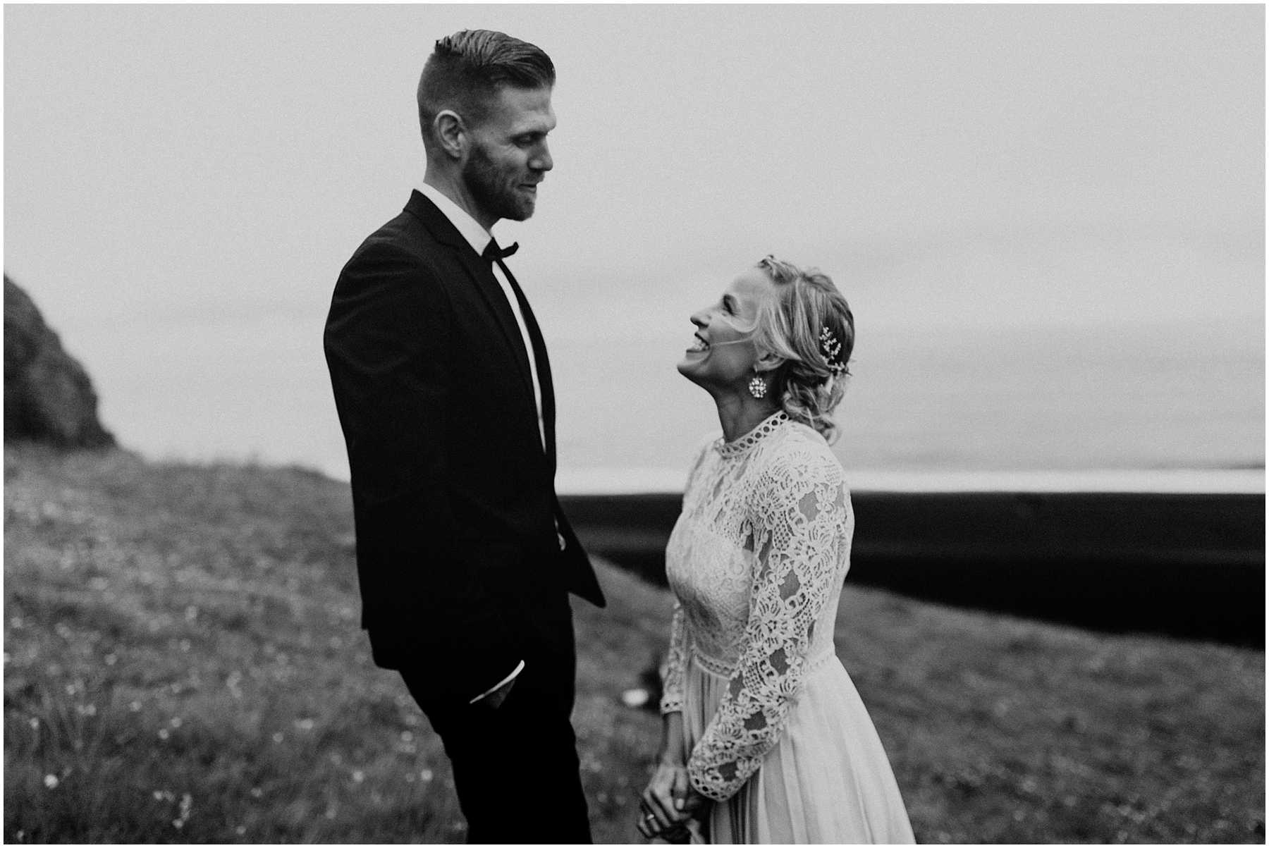 A bride and groom at Black Sands Beach in Vik, Iceland
