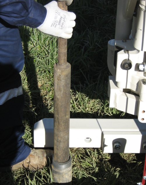 The liner sheath being removed from the 3.25 inch casing. The casing ensures there is no cave in when collecting samples.