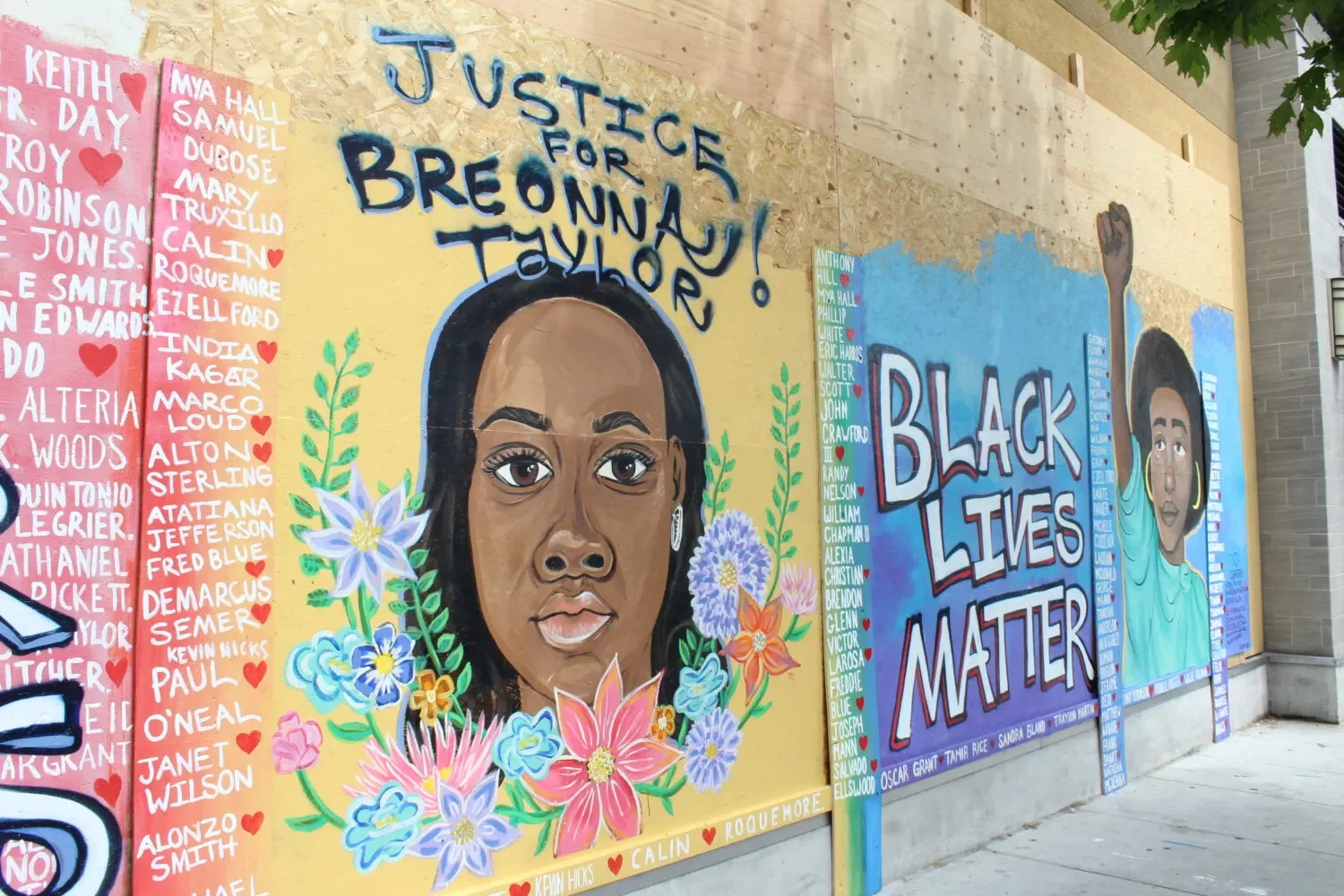 Wall mural of depiction of woman with captions "JUSTICE FOR BREONNA TAYLOR" and "BLACK LIVES MATTER"