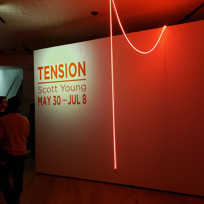 The entrance to Scott Young’s Tension, which begins with a single string of warm neon light. Photo Credit: Alyssa Wroblewski