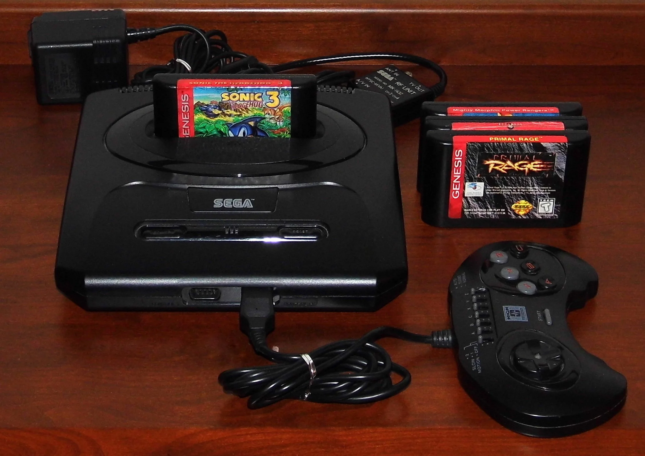Sega Genesis home console with controller and game cartridges, illustrating SEGA’s early home gaming hardware.