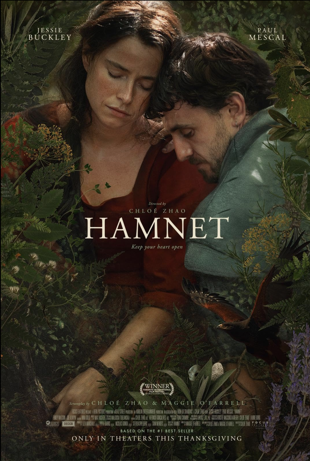 Official poster for Hamnet (2025), showing a woman and a man leaning toward each other amid dense greenery, with the film title centered between them, evoking intimacy, grief, and a close connection to nature.