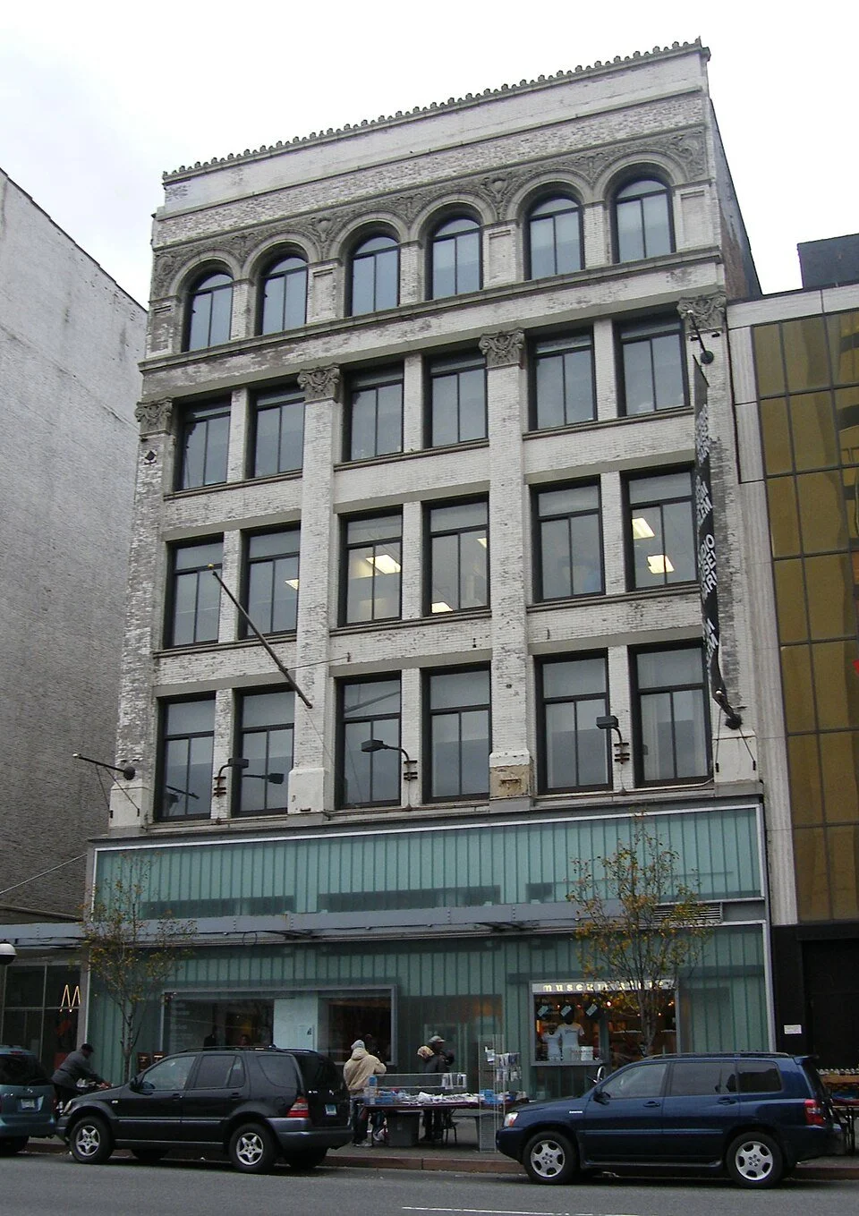 Exterior of building in Harlem, with white exterior and turquoise paneling