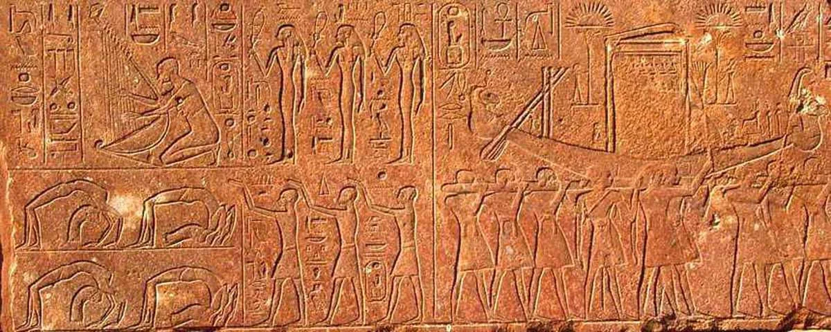 Stone relief showing musicians and dancers in procession, carved on an ancient Egyptian temple wall during the Opet Festival.