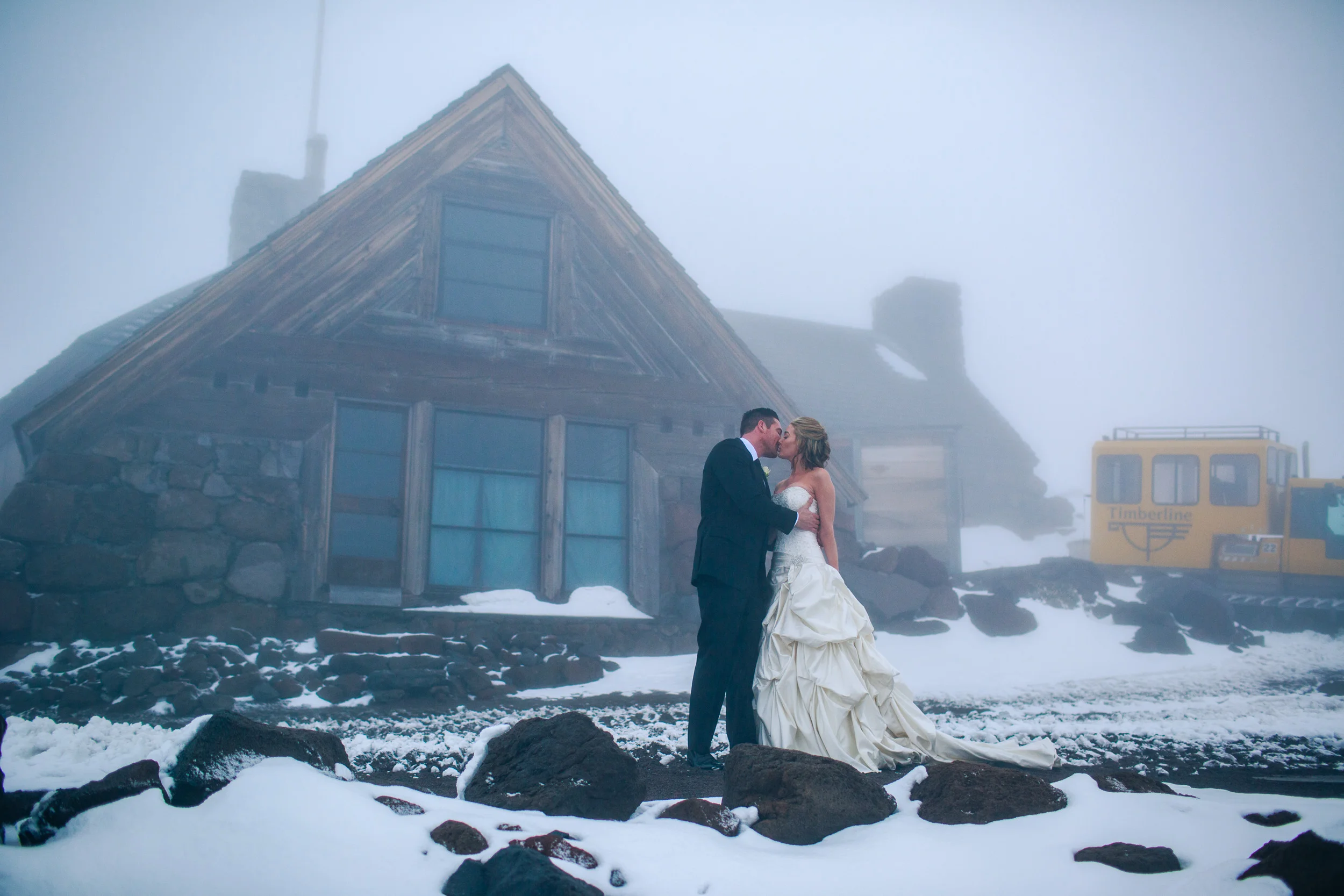 Bride and groom kissing outside Silcox Hut, Oregon