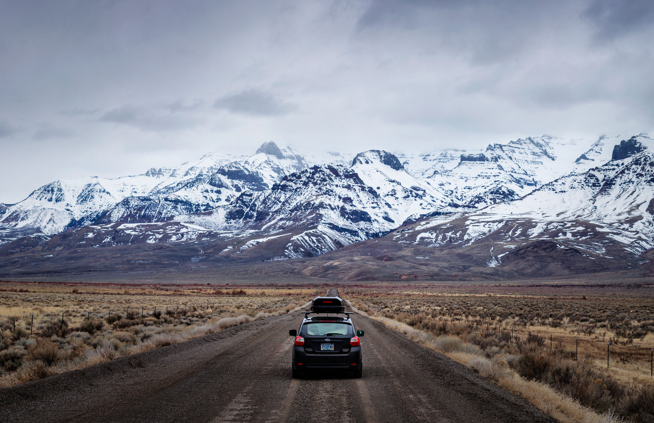 Lone car on the dirt roads along the Steens Mountains heading to the Alvord Desert in Southern Oregon. 