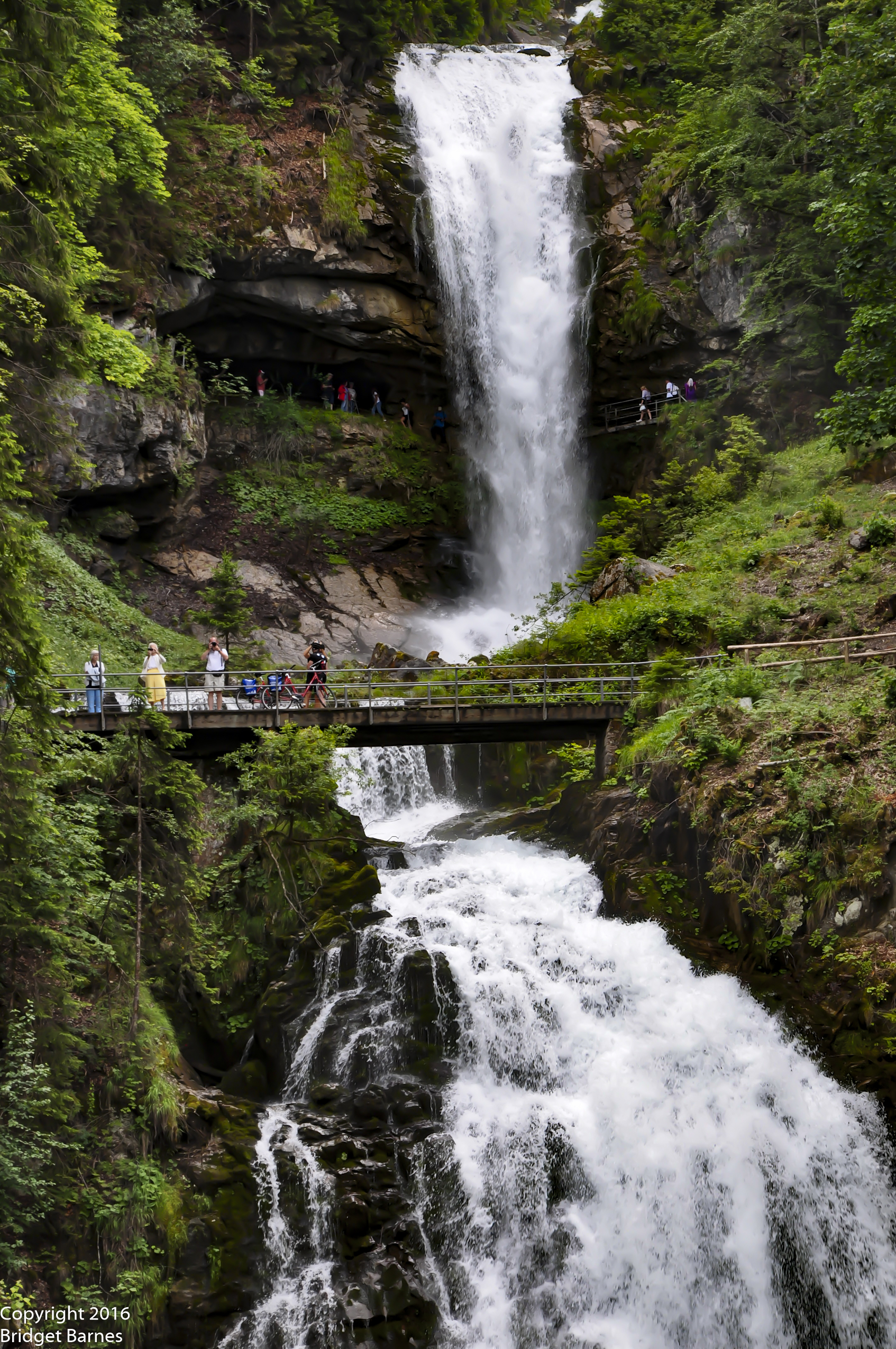 Visitors enjoying the expansive view of Giessbach Falls