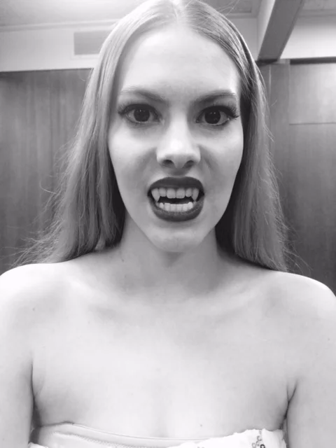 Vampire teeth and contacts with beauty makeup. Shot in black and white for music video. 