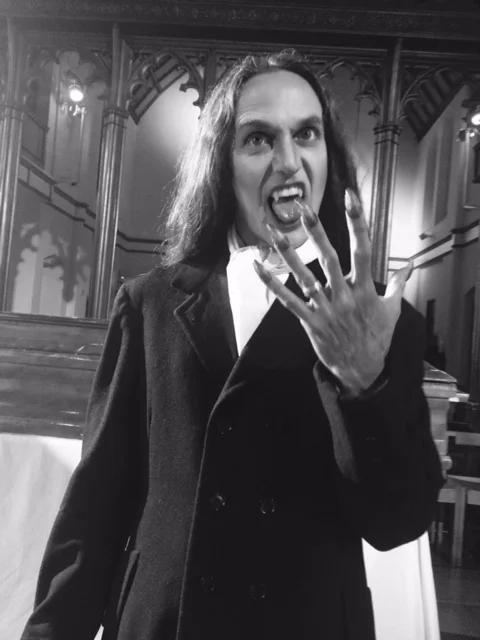 Vampire teeth, contacts, and nails. Shot in black and white for music video. 