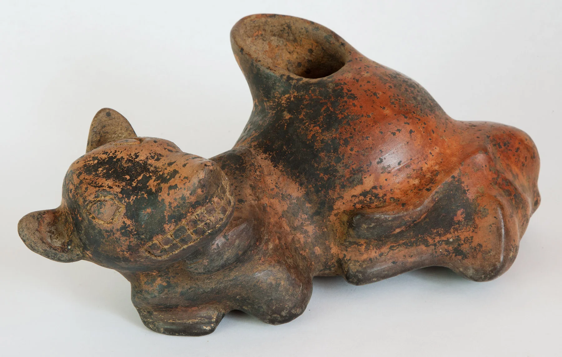 Colima red slipped figure of a reclining dog, perhaps in the act of giving birth. 200 BC-200 AD 4" x 10" x 5-1/4"