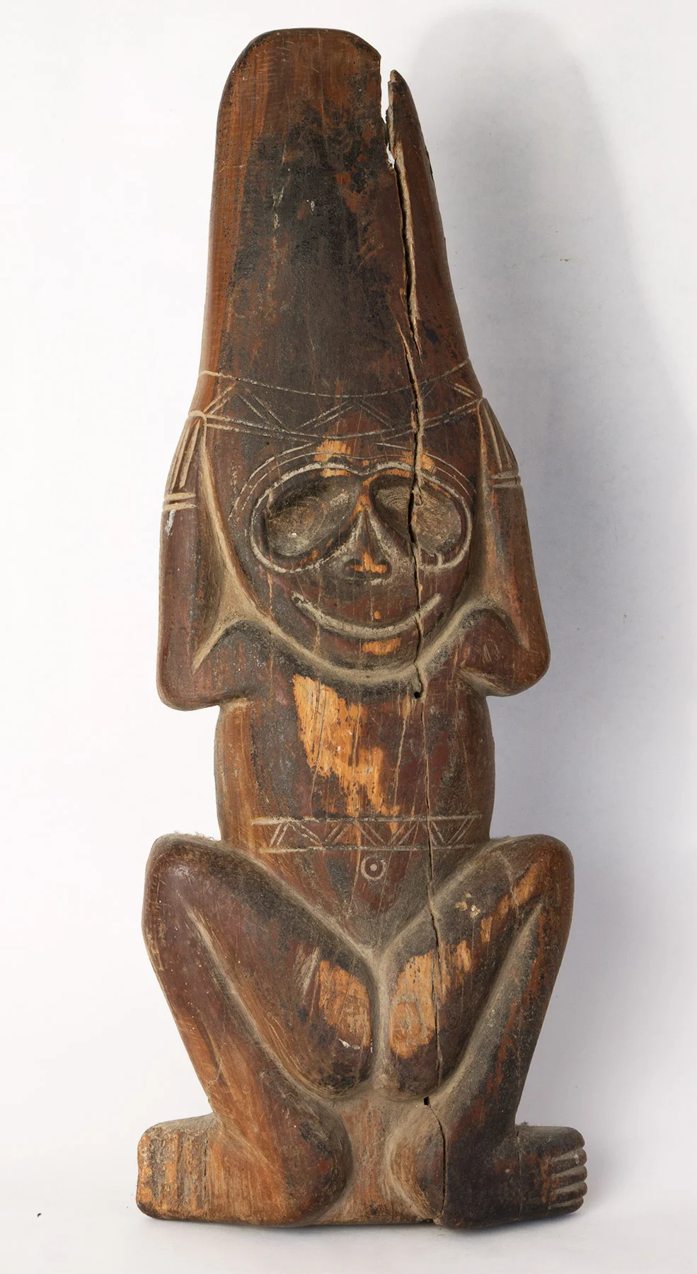 Carib carved wood figure with hands to head. Possibly 16th century. 21" high.