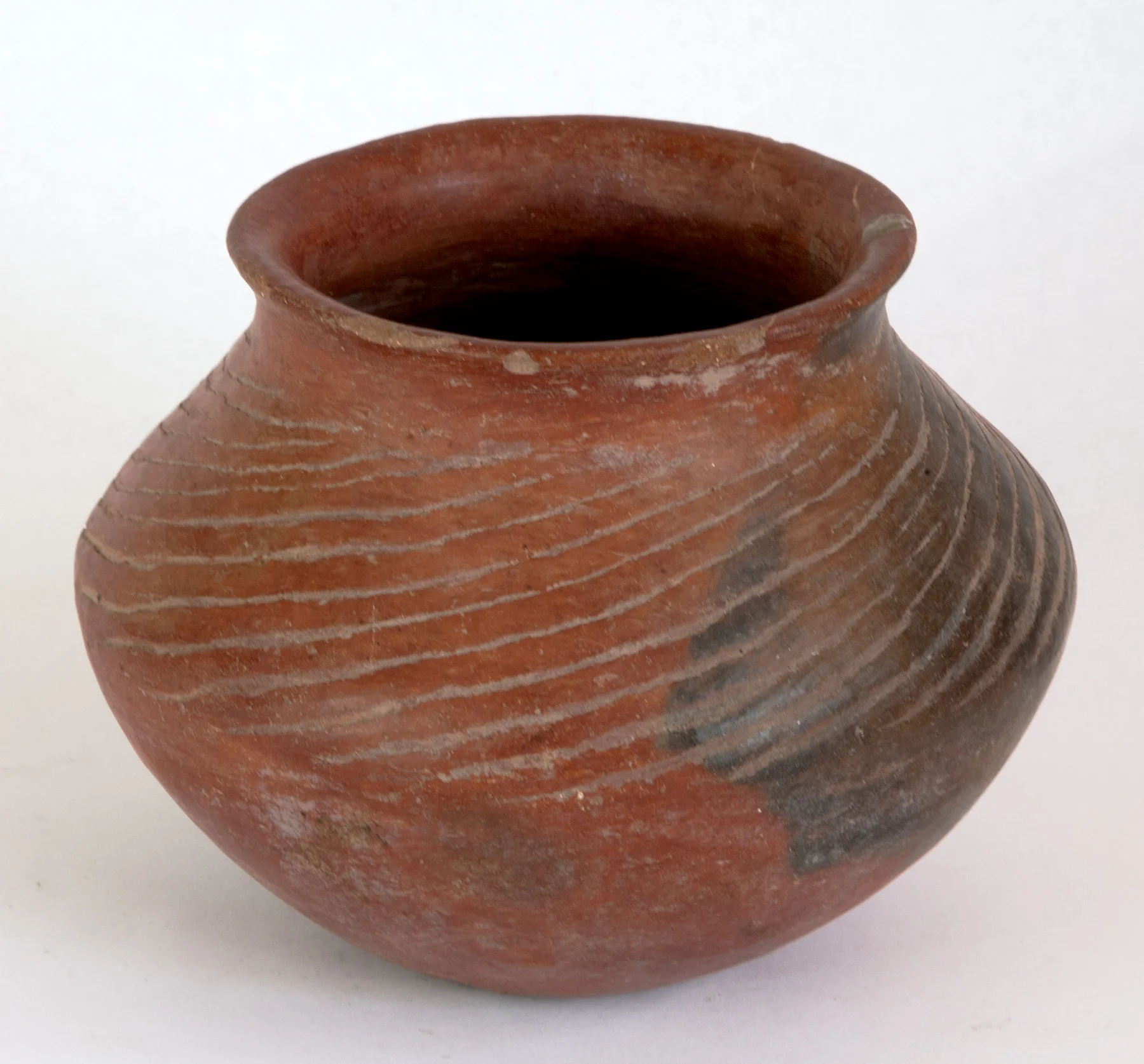Colima red slipped vessel with sweeping Iinear incising made before firing. 200 BC-200 AD 5" H 6-1/2"