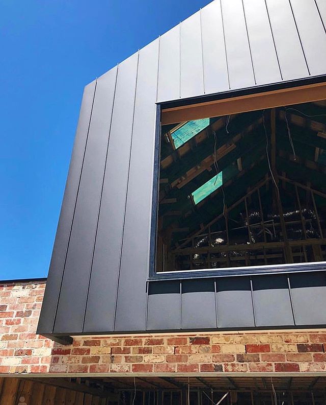 Traditionally Modern. Single - Lock Standing seam with concealed capping detail in PVDF Satin Black Aluminium. A perfect match with recycled reds. Architect - @studioseven_design #archclad #metalcladding #facade #cladding #recycled #aluminium #standi