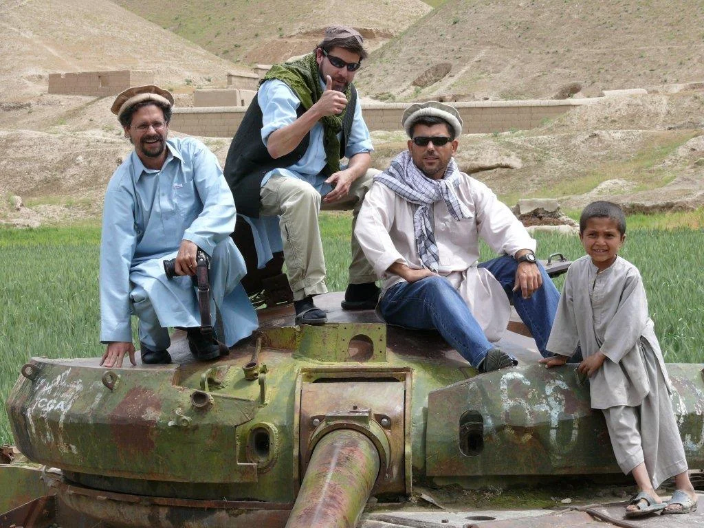 Scott Taylor (centre) with David Pugliese (left) and Sasha Uzinov on a old Soviet tank while unembedded in Afghanistan.