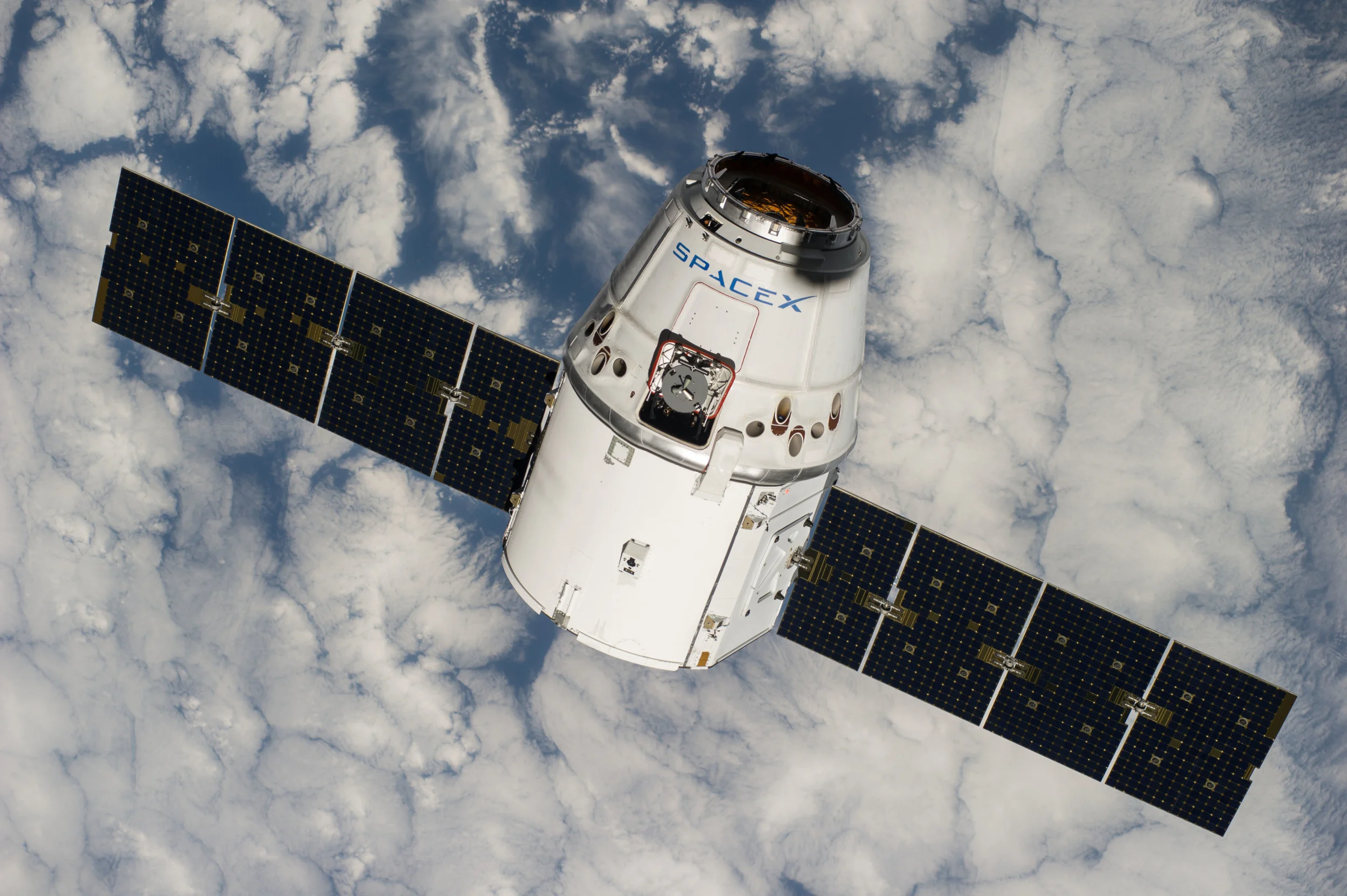 Space X CRS-4 Dragon orbiting above Earth. The recent launch of CRS-5 was delayed, prolonging the delivery of supplies headed for the ISS.