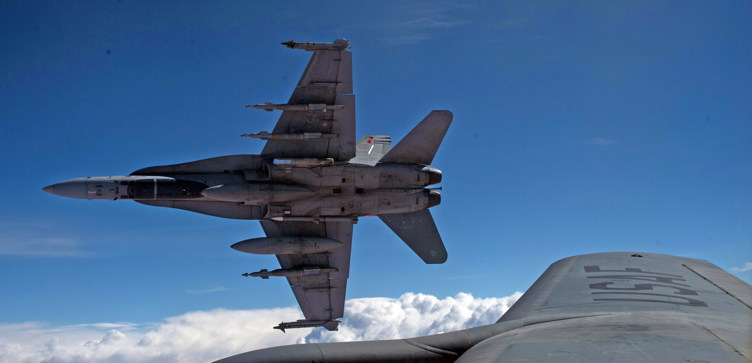 Royal Canadian Air Force CF-188 Hornets are refueled by a KC-135 Stratotanker assigned to the 340th Expeditionary Air Refueling Squadron on October 30, 2014, over Iraq. (Combat Camera).