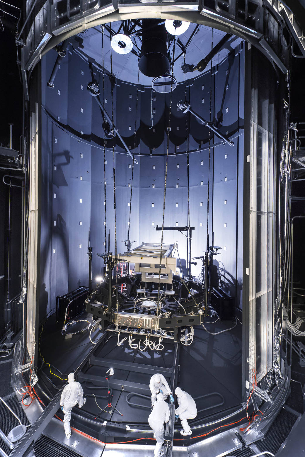 NASA: Outside the enormous mouth of NASA's giant thermal vacuum chamber, called Chamber A, at Johnson Space Center in Houston, engineers and technicians prepare the chamber for testing the James Webb Space Telescope.