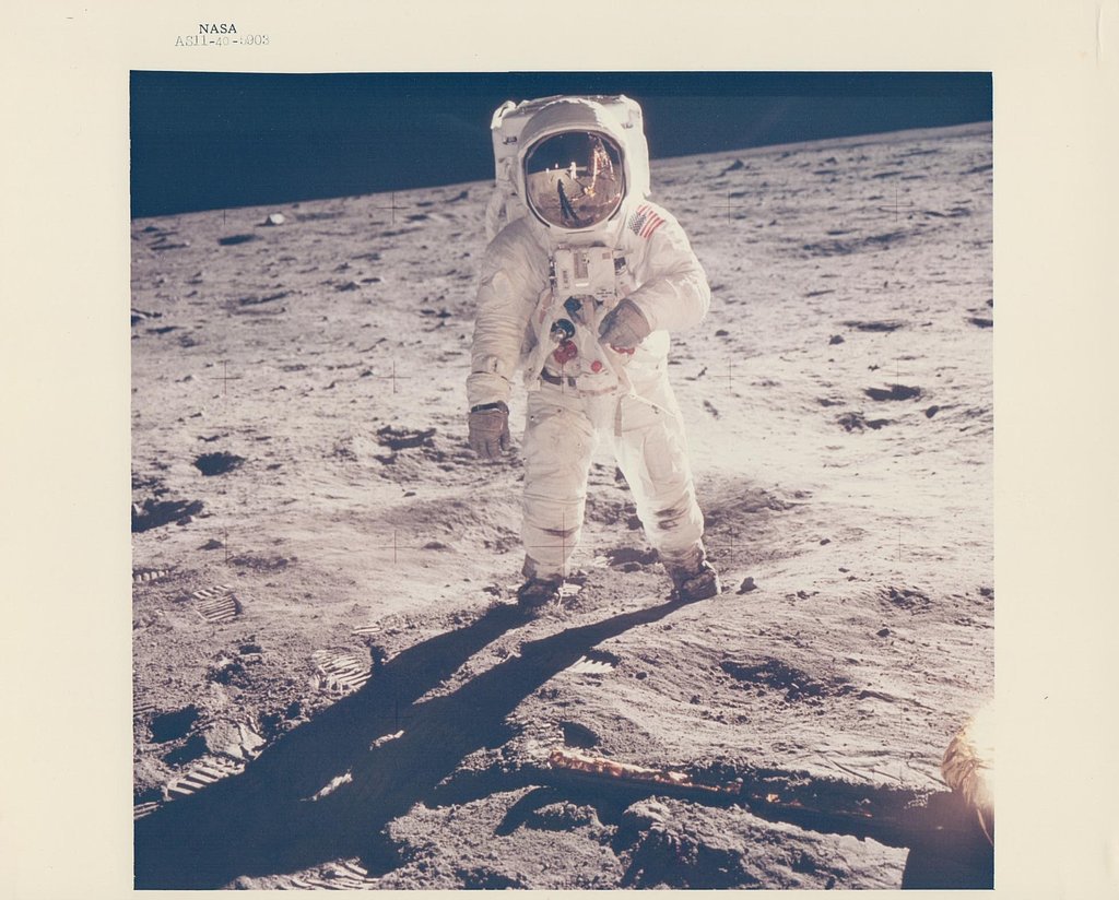The iconic image of Buzz Aldrin's visor reflecting Neil Armstrong during their milestone walk as the first humans on the moon. 