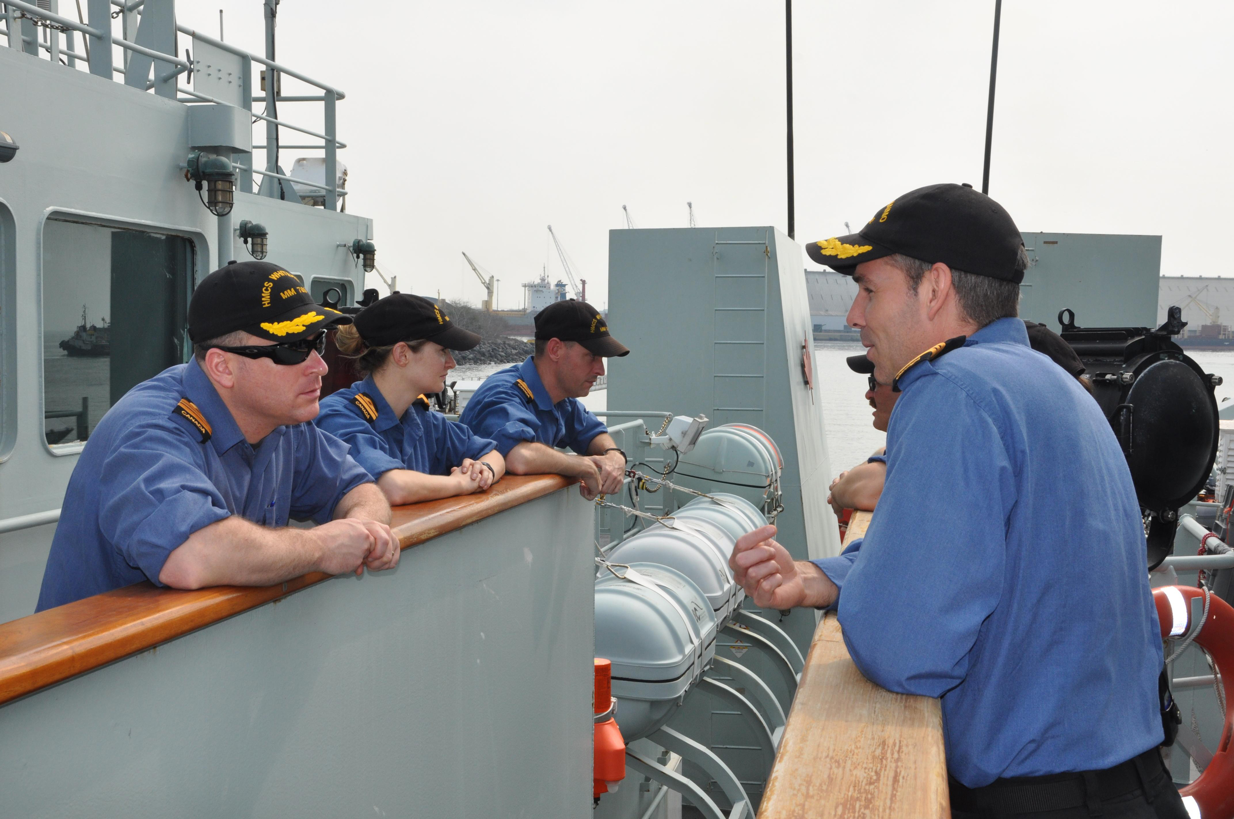 LCdr. Rochon (left), speaks with LCdr. Jeffrey Hopkins, Commanding Officer of HMCS Nanaimo (right) prior to departing from Puerto Quetzal, Guatemala on March 18th, 2015. (Lt. (N) Paul Pendergast)