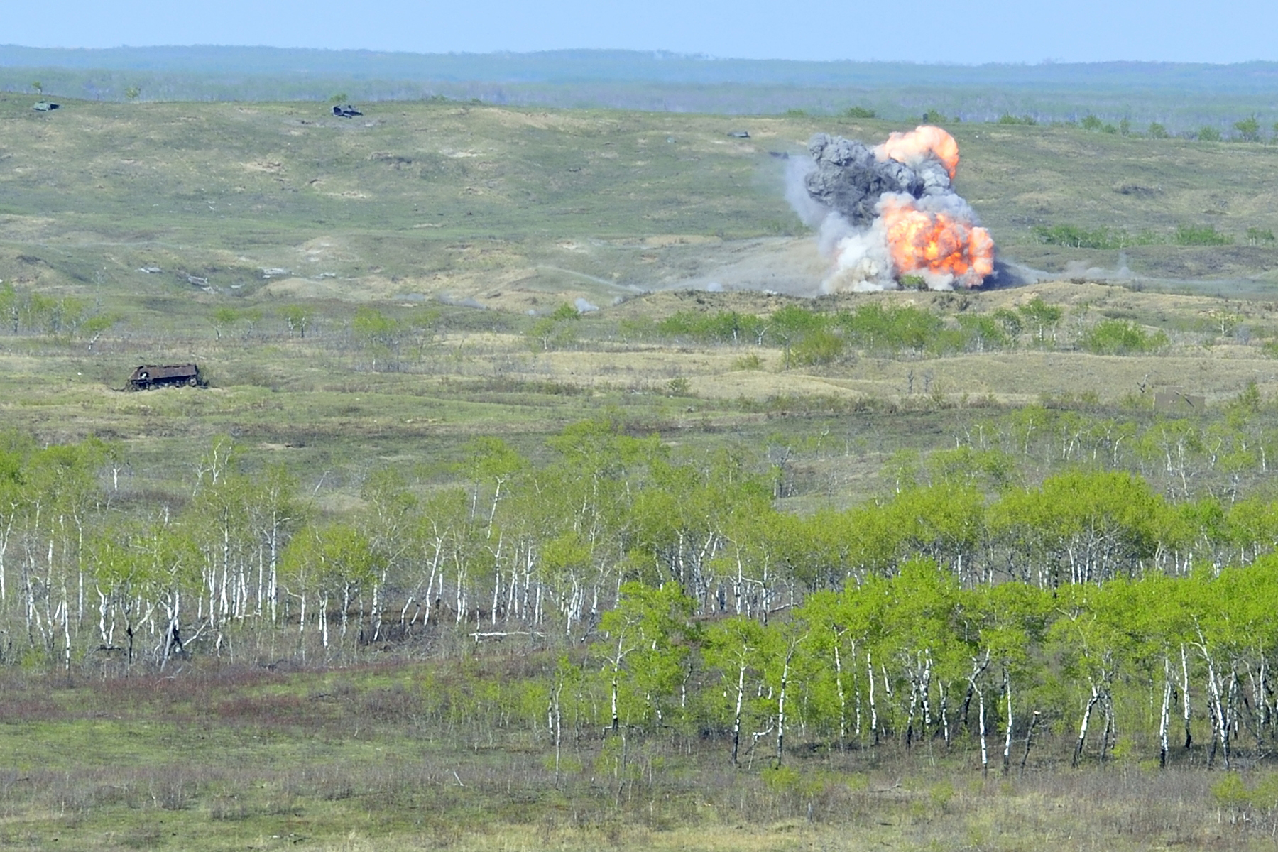 A CF-18 Hornet drops a 300lb bomb amid the rolling hills of CFB Wainwright's vast training area as part of EX MAPLE RESOLVE on May 6, 2015. The exercise, which simulates a large-scale conflict environment, is the largest annual Army exercise in Canada, drawing close to 5,200 Canadian soldiers and 700 members of the Royal Canadian Air Force, along with 700 American troops and 150 British soldiers. (Cpl True-Dee McCarthy, DND)