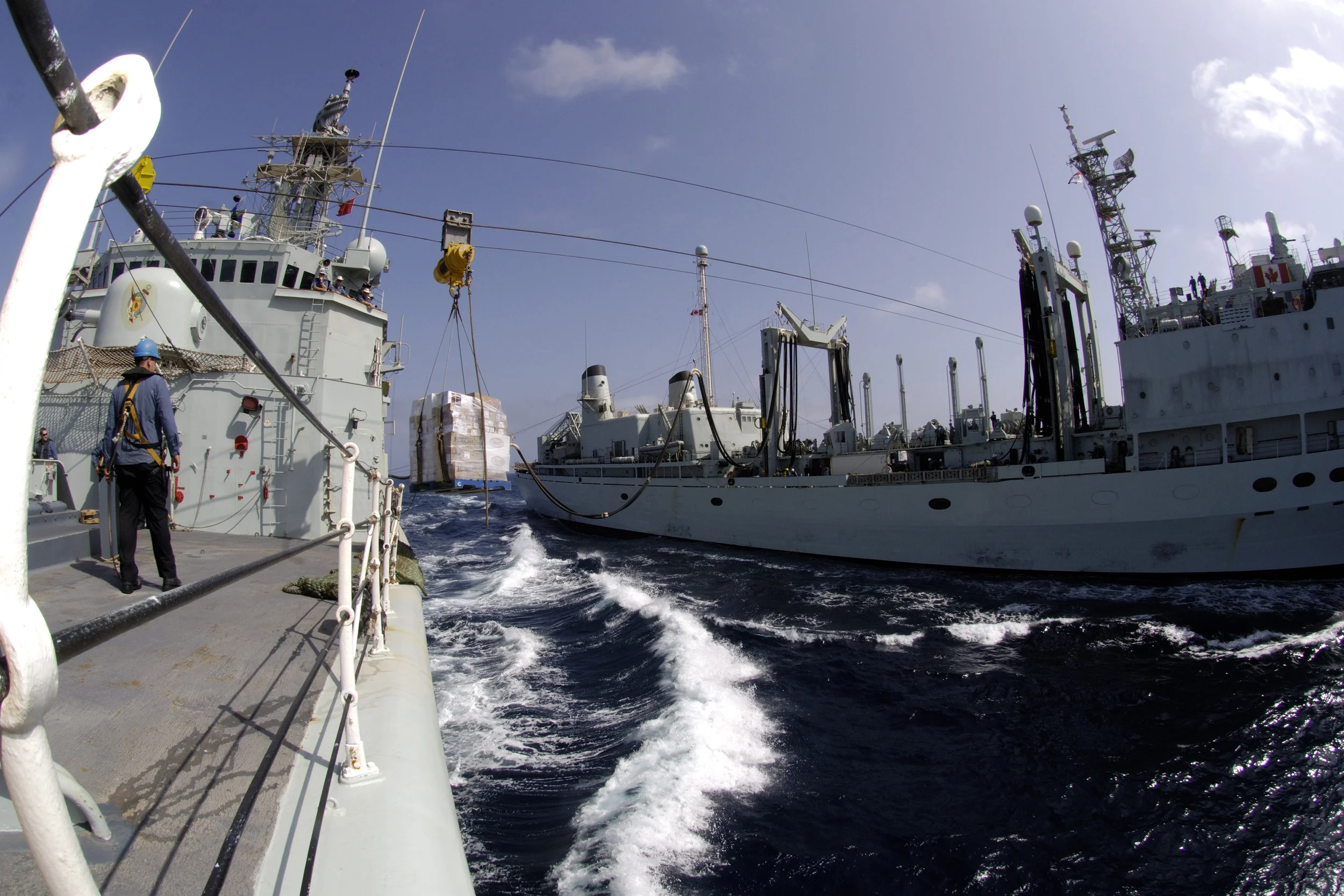 HMCS Protecteur transfers a pallet loaded with food to HMCS Iroquois during a Replenishment At Sea (RAS) in the Arabian Sea, September 2008. Since 2014, the Royal Canadian Navy has been without a resupply capability after Protecteur caught fire at sea and HMCS Preserver - the RCN's other supply ship - was taken offline due to cracks in the hull. (DND)