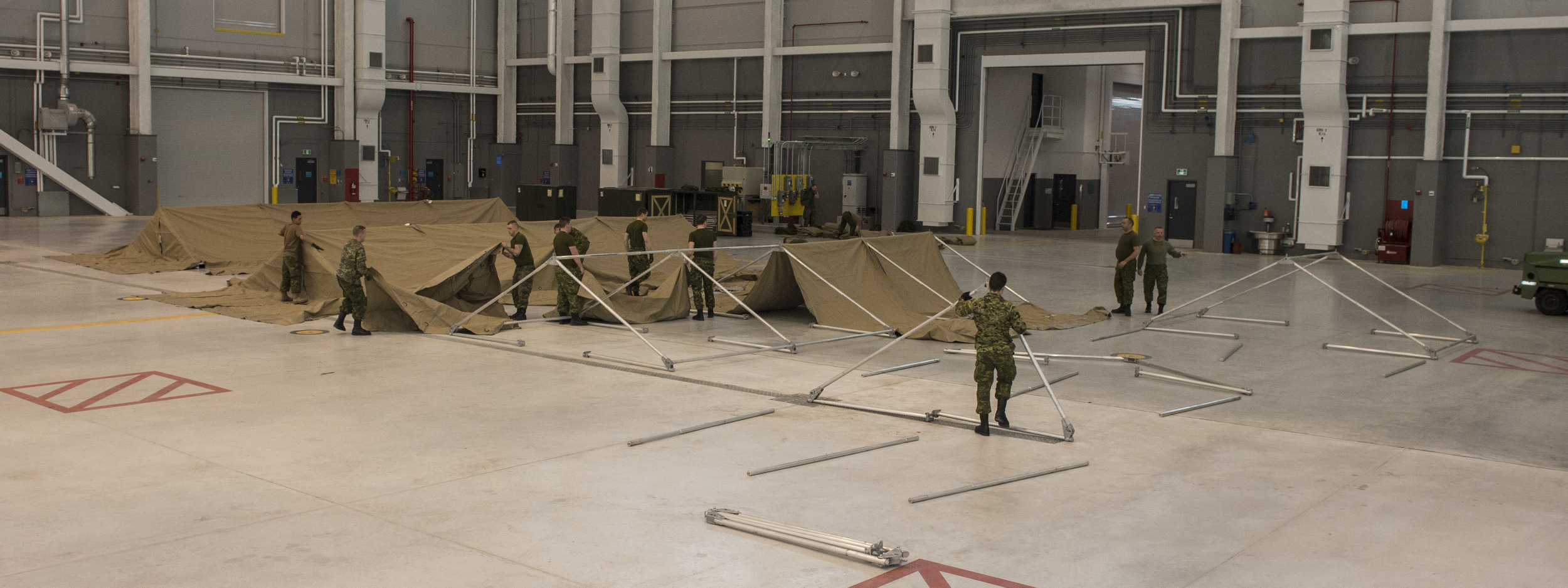 Members of the Disaster Assistance Response Team (DART), check the serviceability of modular - or "mod" - tents at CFB Trenton during Exercise READY RENAISSANCE 2015 on February 23, 2015.