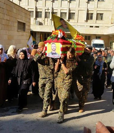 Images posted on Facebook show John Gallagher's coffin being carried through the streets of Syria wrapped in a Canadian flag and the flag of the Kurdish YPG guerillas.