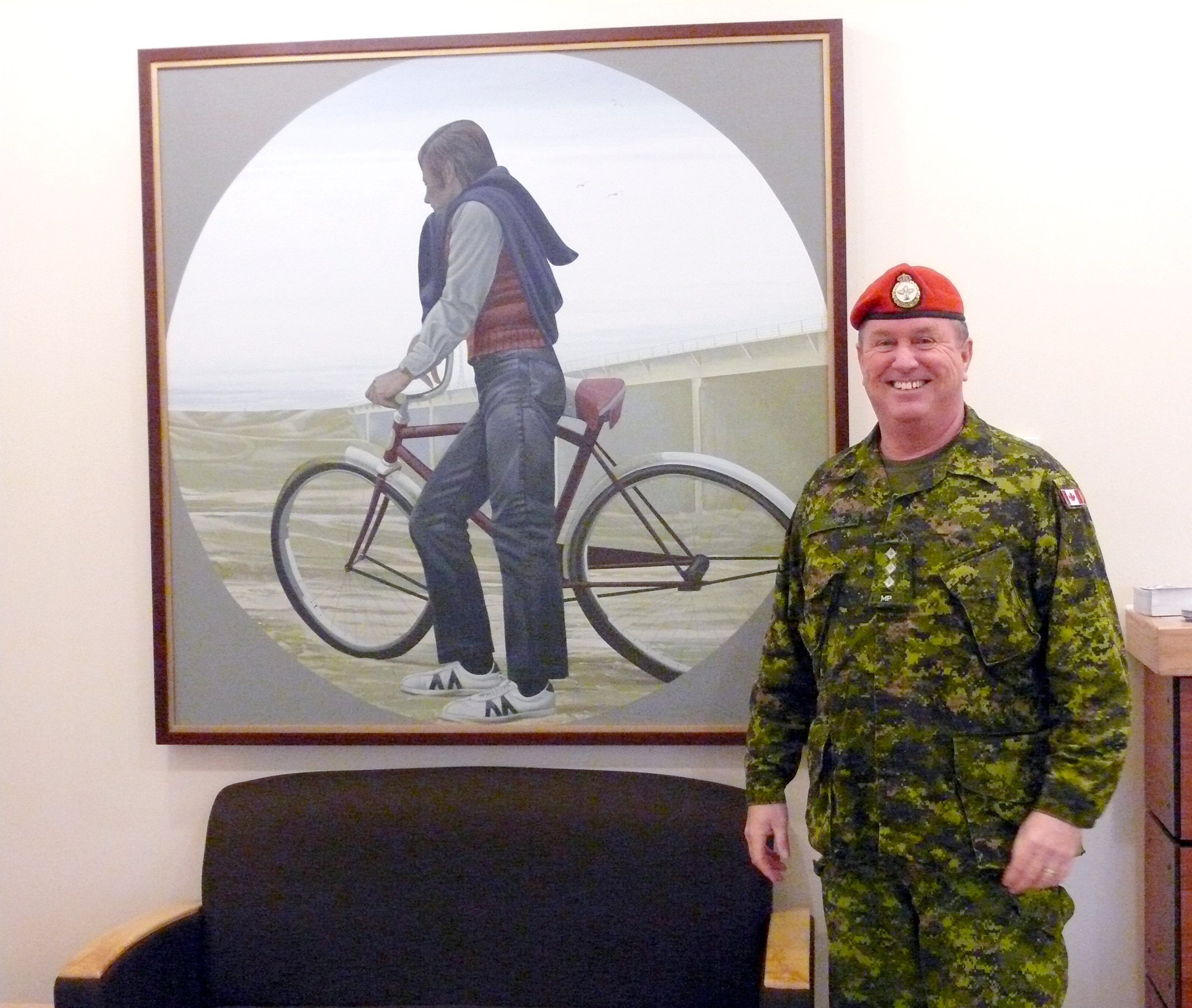 Captain K.B. Lamorie stands before one of the paintings from the Canada Council Art Bank currently on display at the transition centre at CFB Petawawa. This initiative by Her Excellency Sharon Johnston, who graduated from the University of Toronto as a physical and occupational therapist, is bringing little-seen paintings and sculptures into a traditionally austere environment in an effort to help CAF members dealing with PTSD. (esprit de corps)