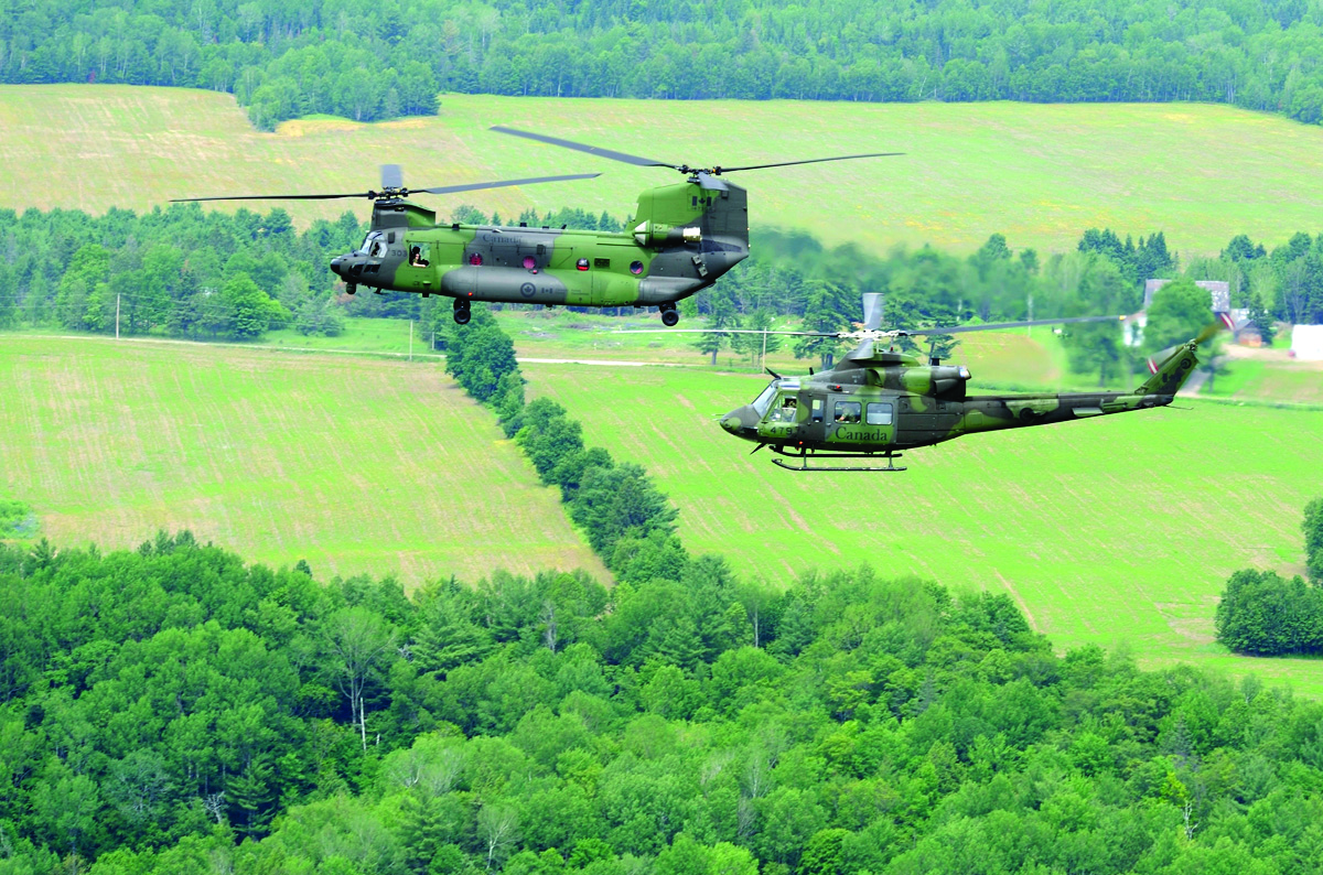 Canada's new CH-147F Chinook medium- to heavy-lift helicopter makes its way from the nation's capital, up the Ottawa Valley, to its new home at Canadian Forces Base Petawawa, Ont., on June 27, 2013. A CH-146 Griffon helicopter accompanies the Chinook. Canada and the RCAF have purchased 15 of these Boeing helicopters. (CPL DARCY LEFEBVRE, DND)