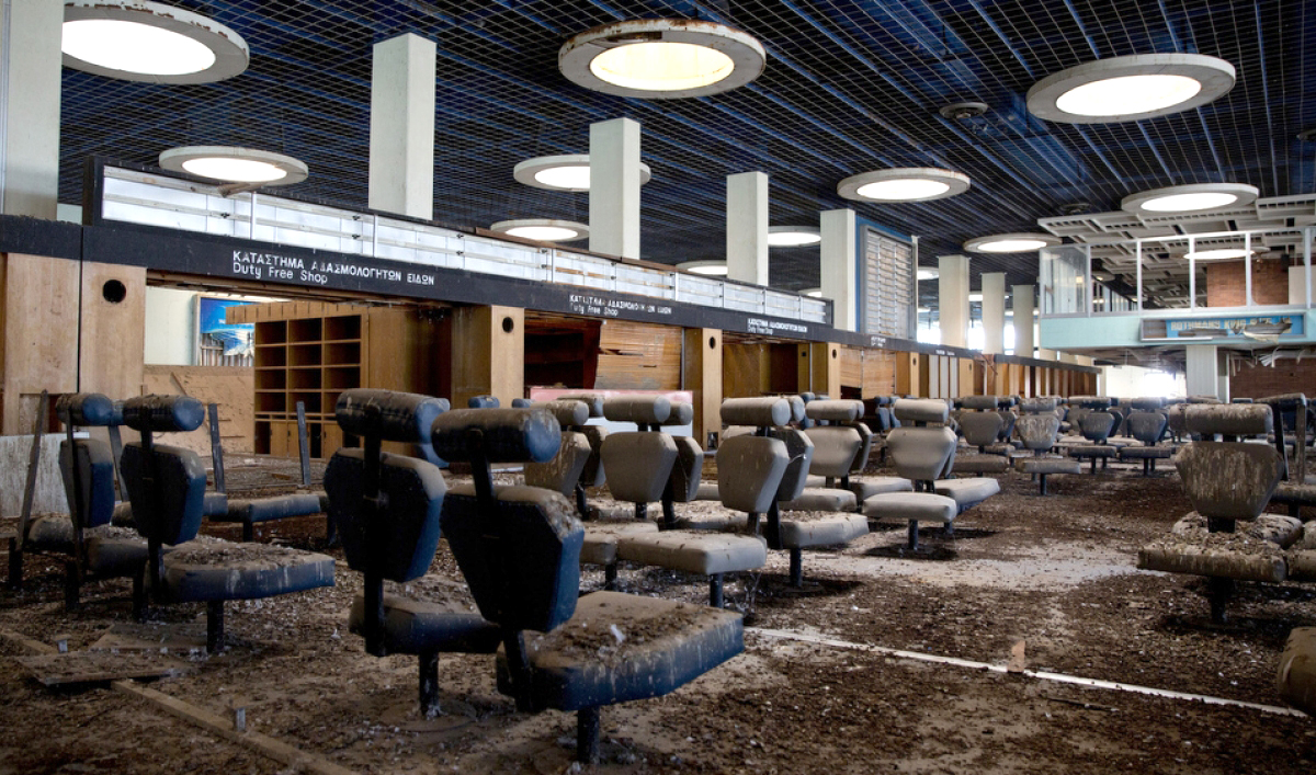 Amid decades-worth of debris and peeling paintwork, the waiting areas, check-in counters and passport control desks at the Nicosia airport remain as they were when abandoned over 40 years ago. (Neil Hall, Pri)