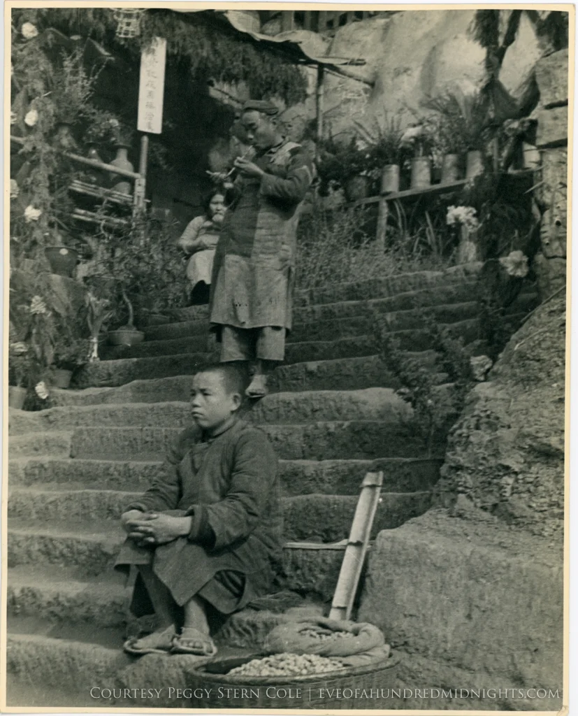 Boy by peanuts and opium smoker on steps from large print.jpg
