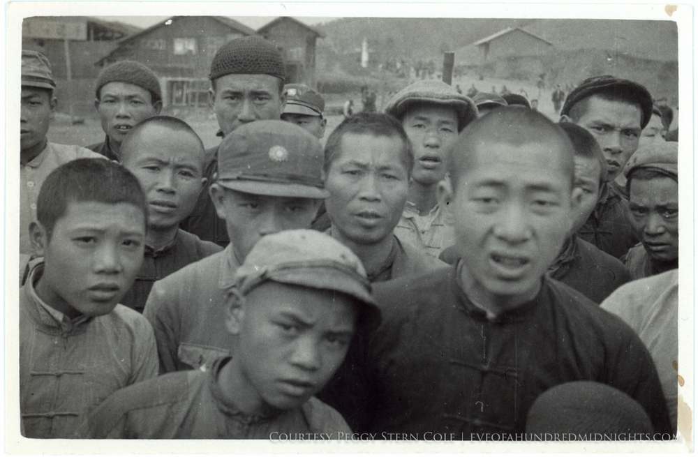 Angry or skeptical chinese men looking at Camera from small print.tif.jpg