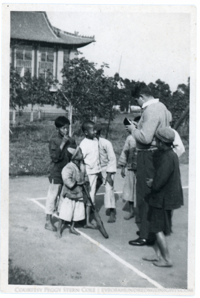 Student buying racket from kids at Lingnan.jpg