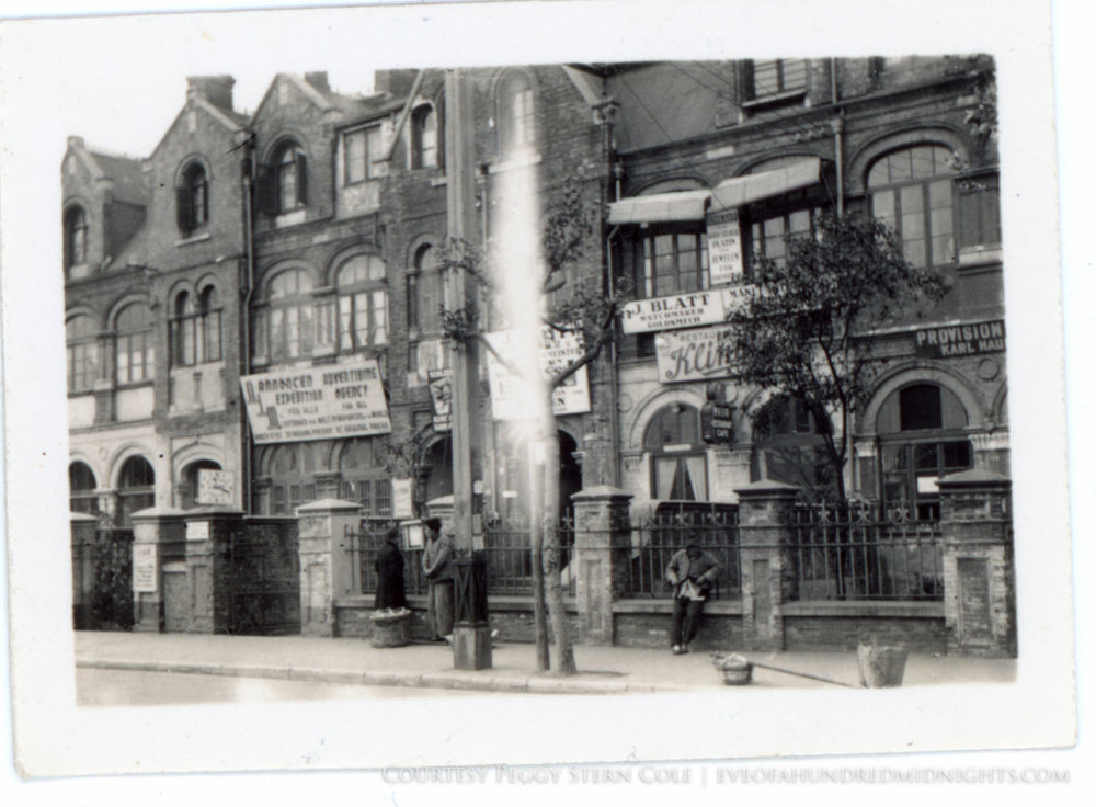 Man Leaning on Fence in Front of J. Blatt Watchmaker.jpg