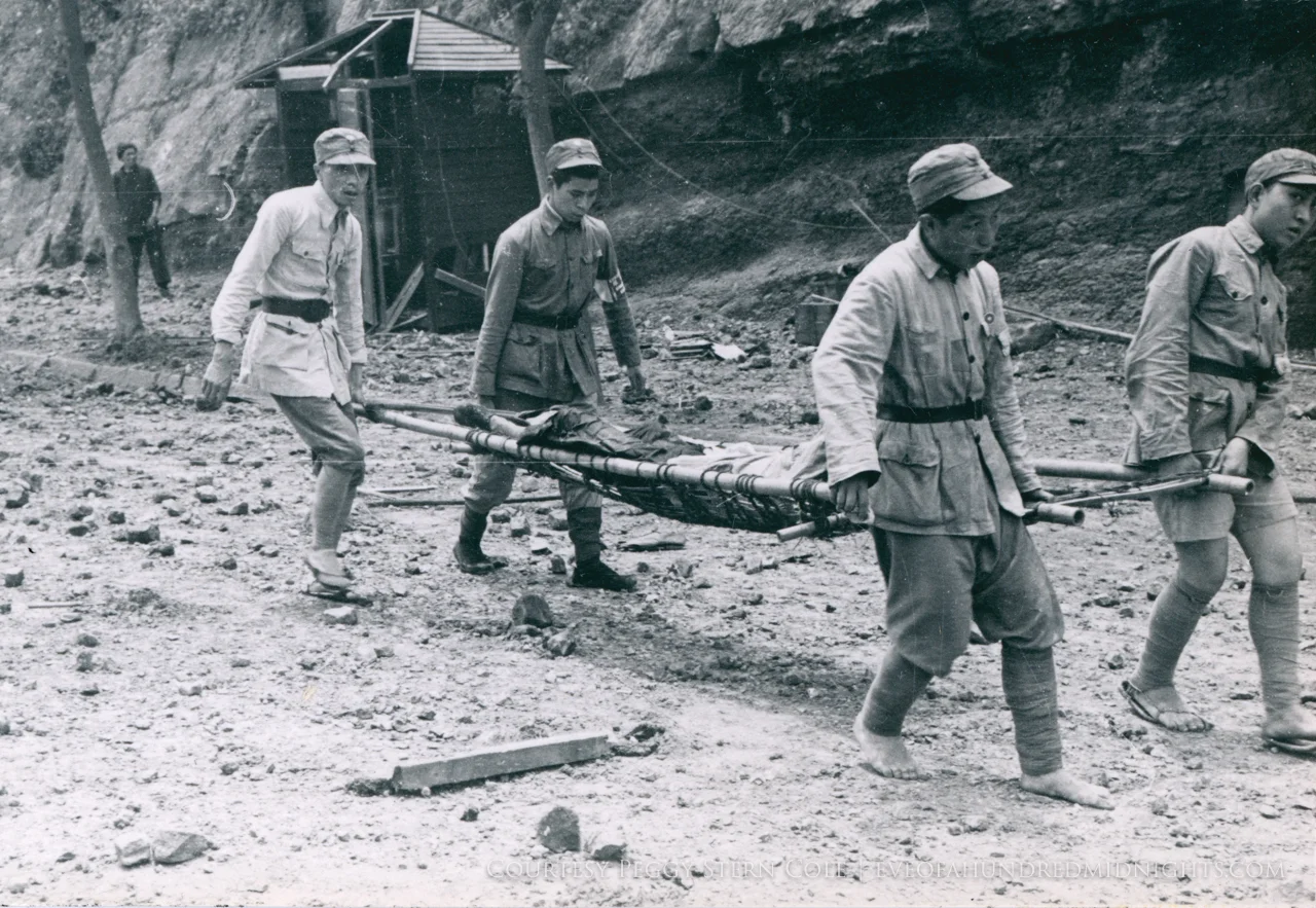 Men straining at stretcher weight.jpg