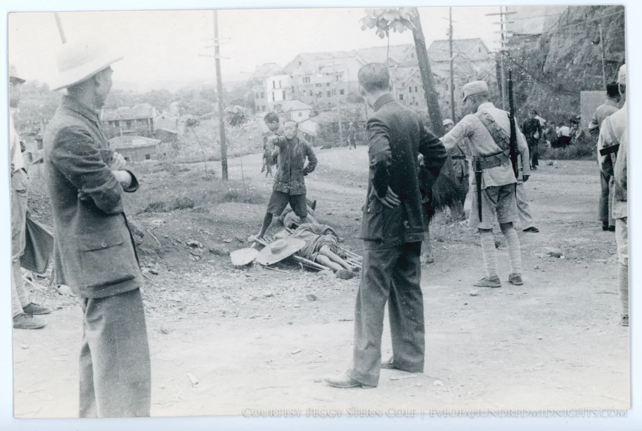 People standing by body on stretcher.jpg