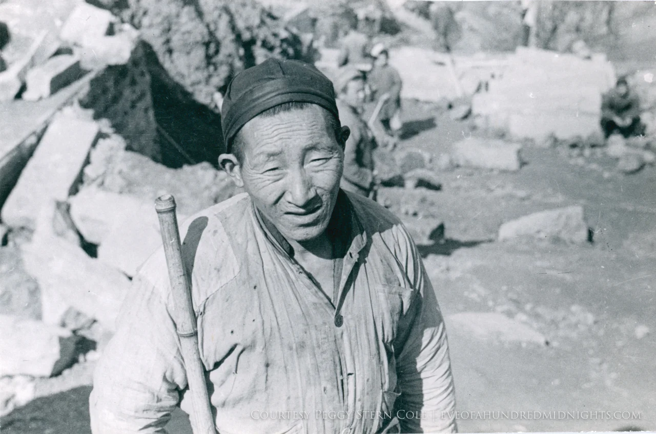 Man with staff squinting at camera.jpg