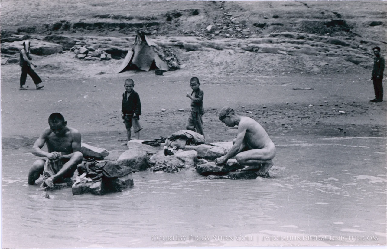 Men Naked as they wash clothes in river.jpg