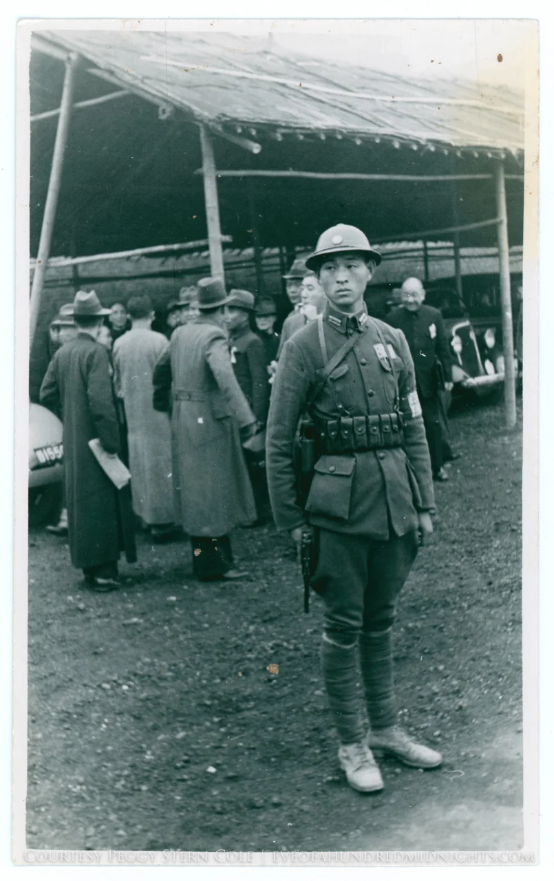 Soldier guarding VIPs with pistol in hand.jpg