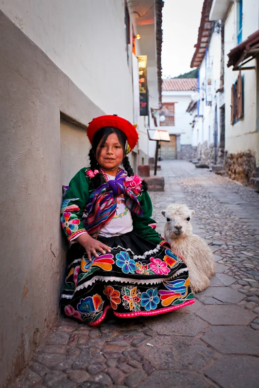 Girl with baby alpaca, Cusco, Peru 2010.