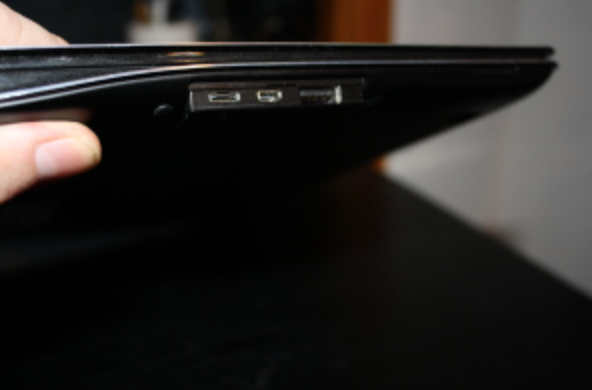 That's actually the ethernet port on the left: you connect the network cable by way of an included dongle.