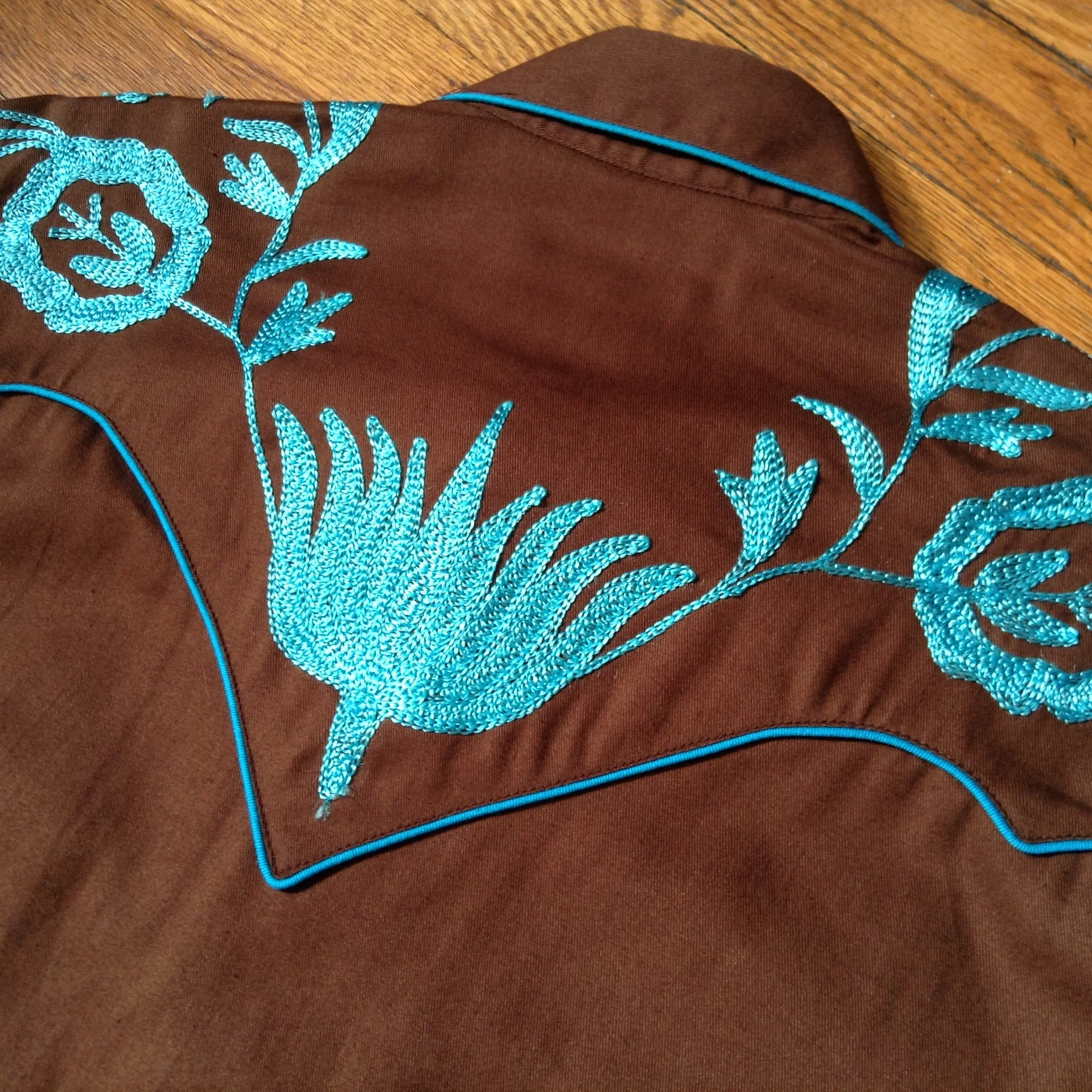 Turquoise Flowers on Brown Shirt