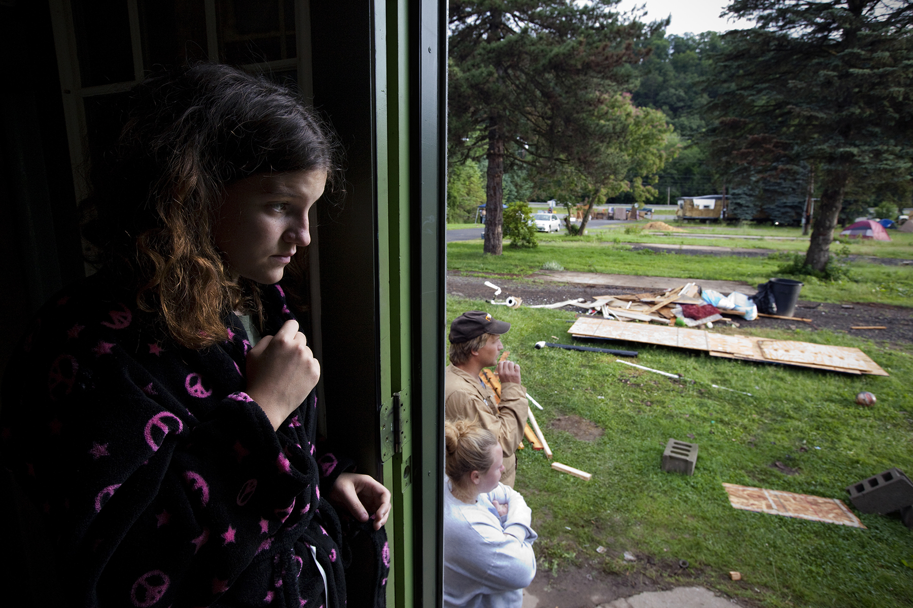 On the last morning in Riverdale Mobile Park, Alexa Daniels, 14, looks out at the remains of her neighborhood. Her parents, April and Eric, surrendered their home to Aqua America because they could not afford the moving costs.